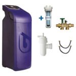 Purple residential water softener with a cartridge filter, shut-off valve, drain trap, and two hoses/bypass lines included.